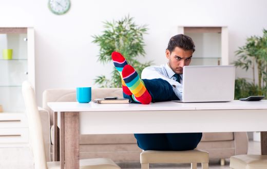 A man sitting at a desk with feet on the desk wearing colorful socks thinking about where the legal industry is headed 